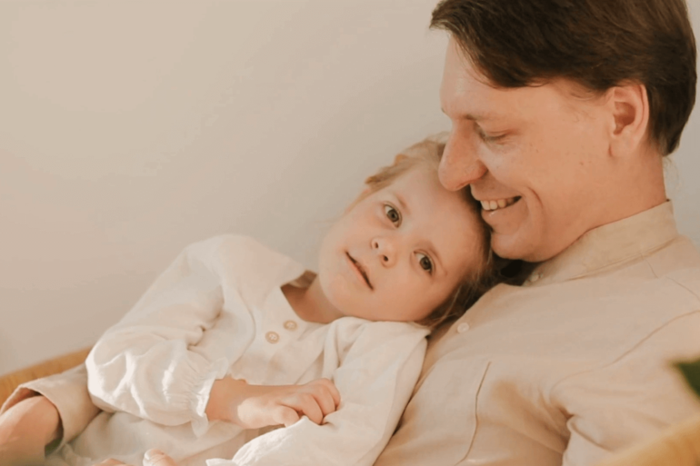 Child and man sitting together.