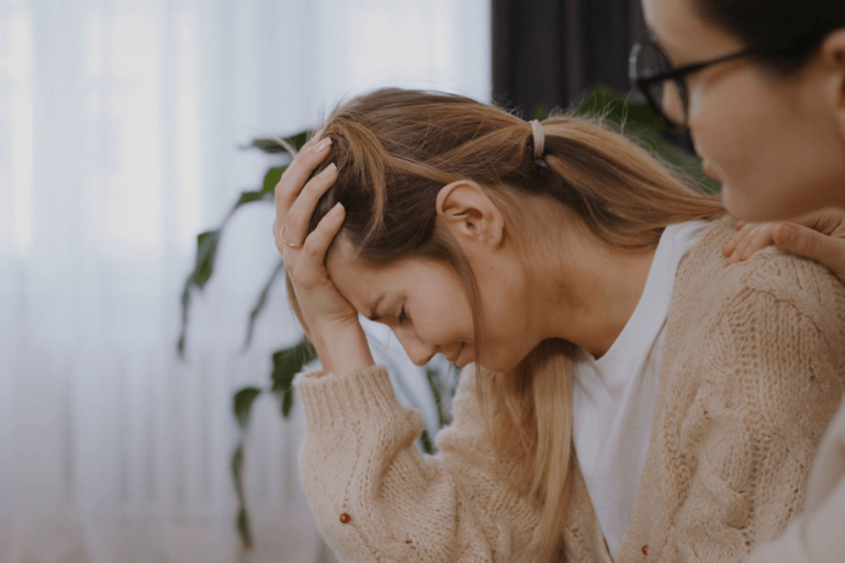 Crying woman comforted.